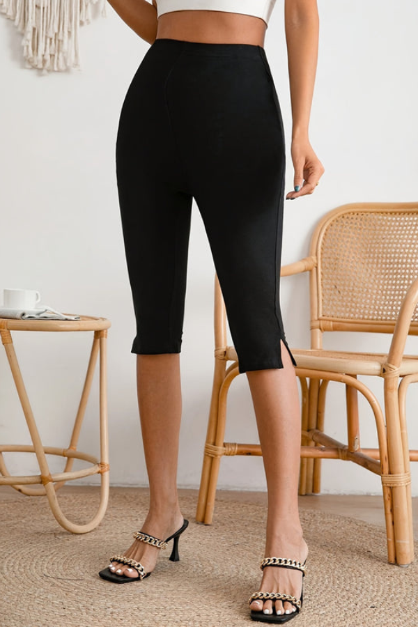 Black women's slim-fit stretch cropped pants with a stylish slit hem, perfect for casual or office wear.