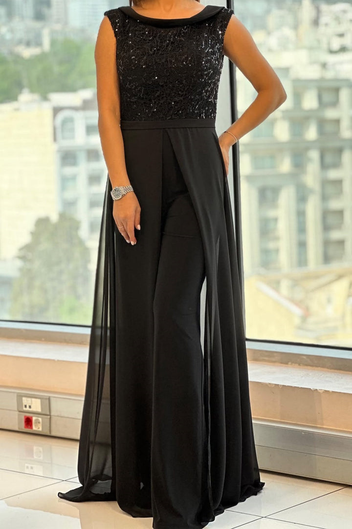 Black women's textured panel jumpsuit with a classic crew neck. Stylish and elegant one-piece for day to night wear.