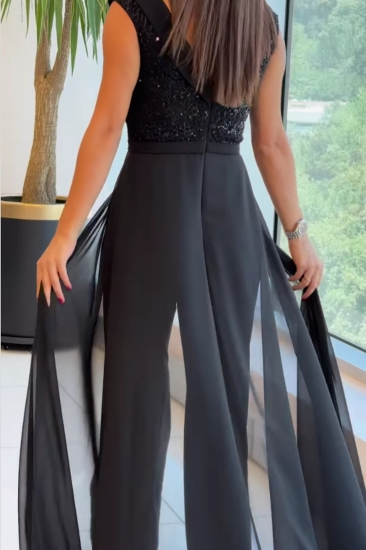 Versatile black women's jumpsuit featuring stylish textured panels & a comfortable crew neck. Perfect for any occasion.