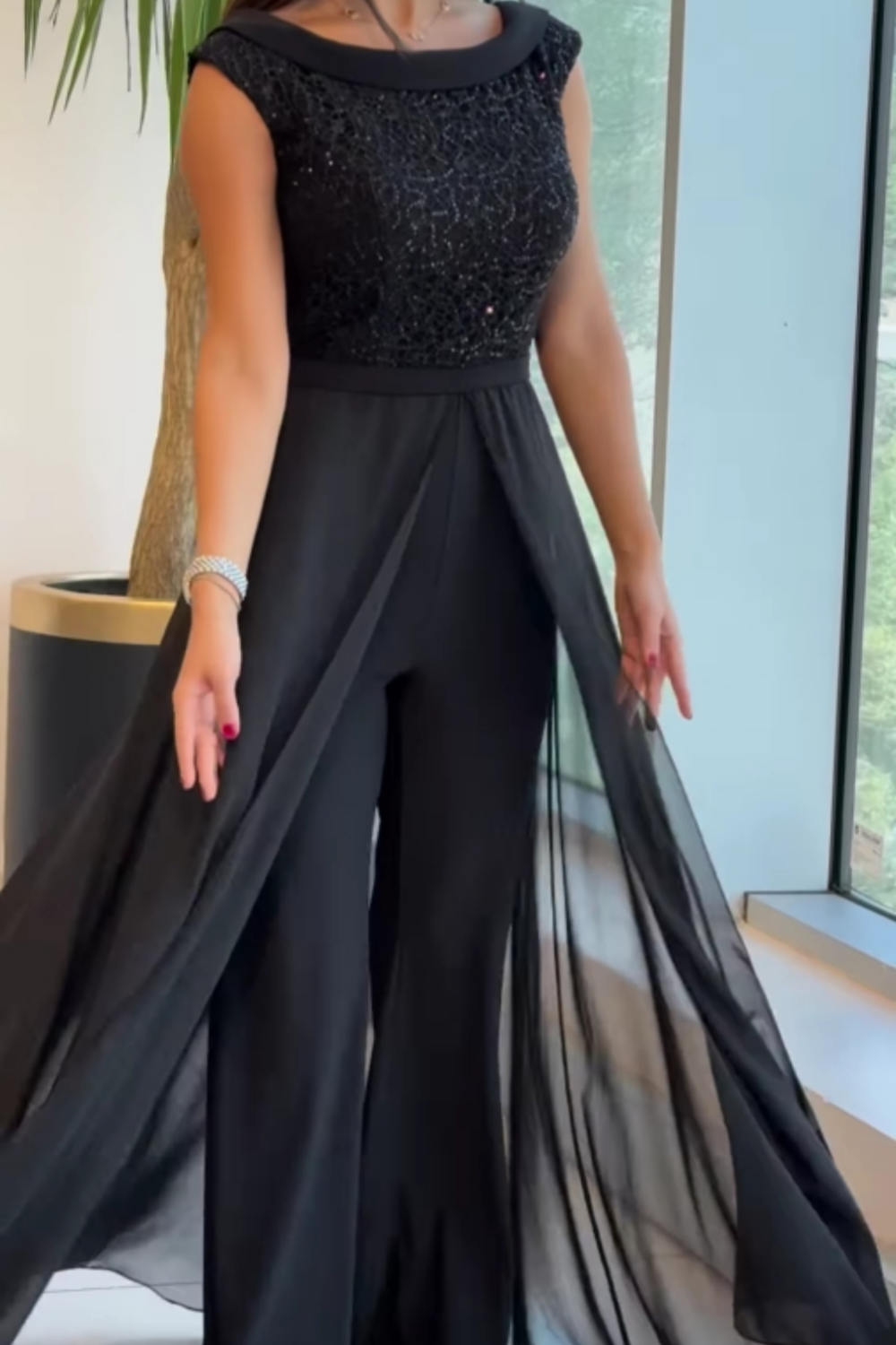 Modern women's black jumpsuit with elegant textured panels & a chic crew neck. Comfortable & flattering one-piece outfit.