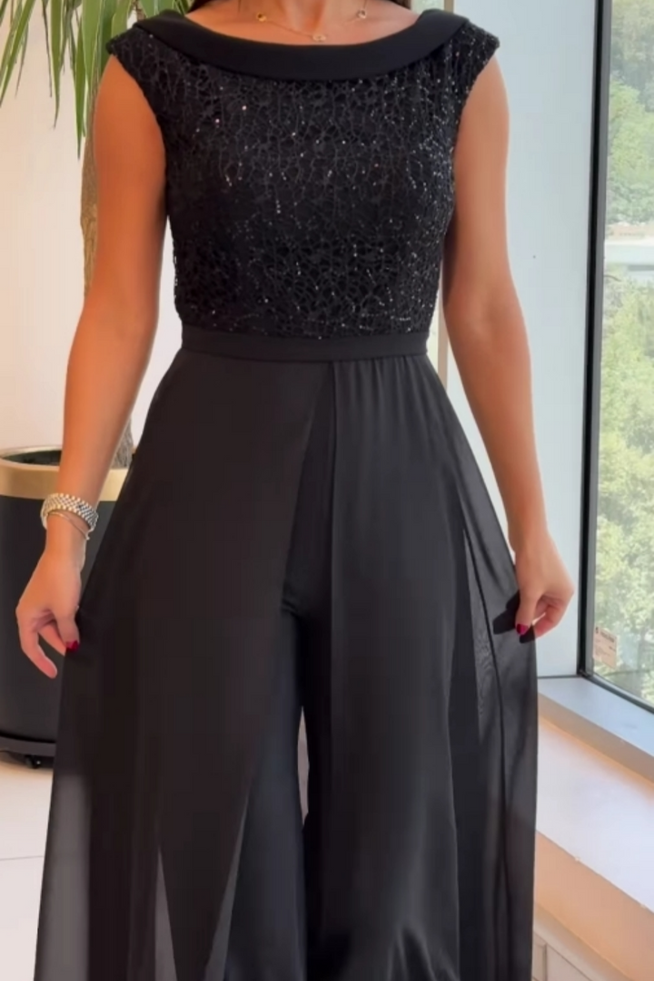 Stylish black women's textured jumpsuit with a sophisticated crew neck. This versatile one-piece offers comfort & elegance.