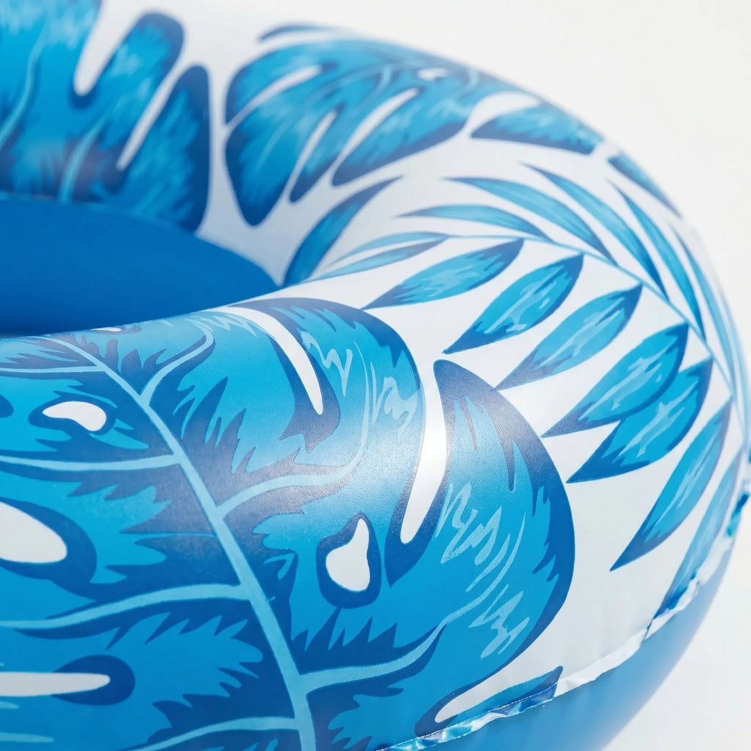 Vibrant blue floating pool chair, an adult water lounge with integrated cup holders for a tropical feel.