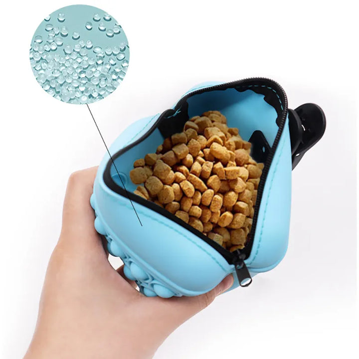 Hand holding a rosa Pop-It fidget toy keychain with zipper, showing its stress relief function