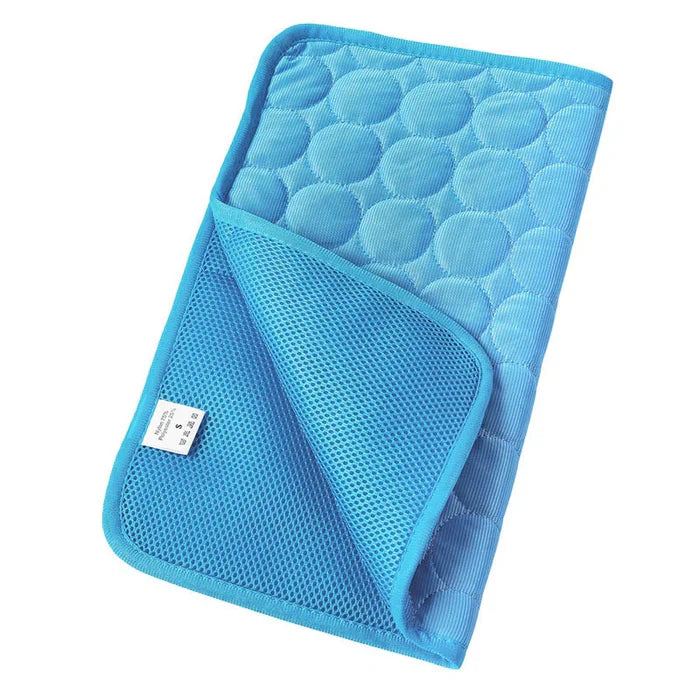 Dog comfortably resting on a blue self-cooling gel pet mat, enjoying heat relief