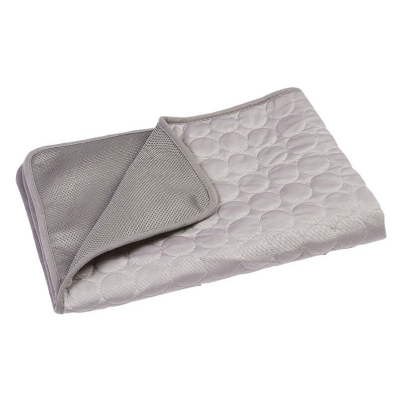 Self-cooling pet mat with a dog toy nearby, highlighting pet comfort and play area