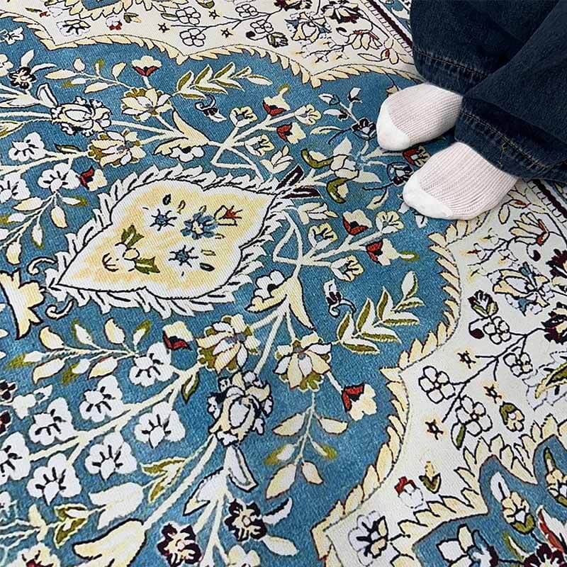 Detailed corner of bohemian floral area rug, showcasing fringed edge and rich texture, entryway mat potential.