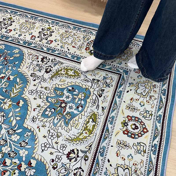 Overhead shot of a decorative bohemian floral area rug, featuring a diverse palette and classic design.