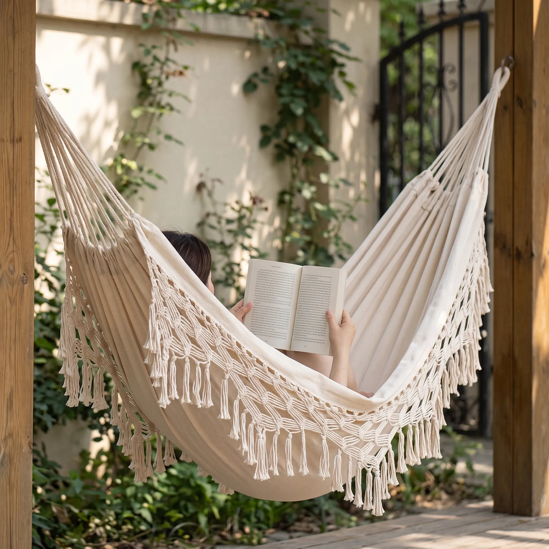 Cotton bohemian hanging hammock with tassels, perfect for outdoor living, garden swing, or patio decor.