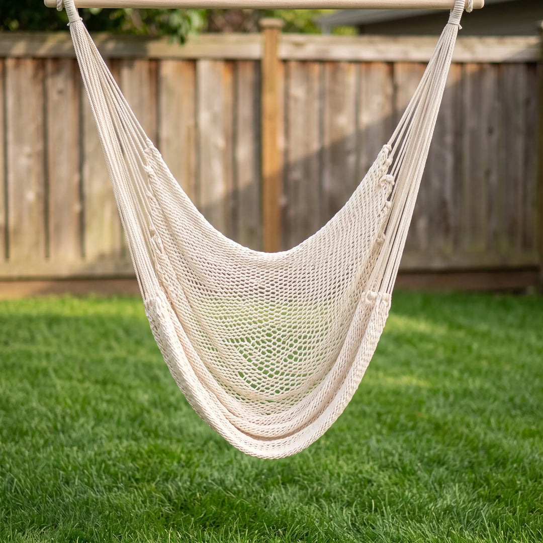 Unisex bohemian outdoor hanging chair with tasseled fringe, ideal for relaxation and patio furniture.