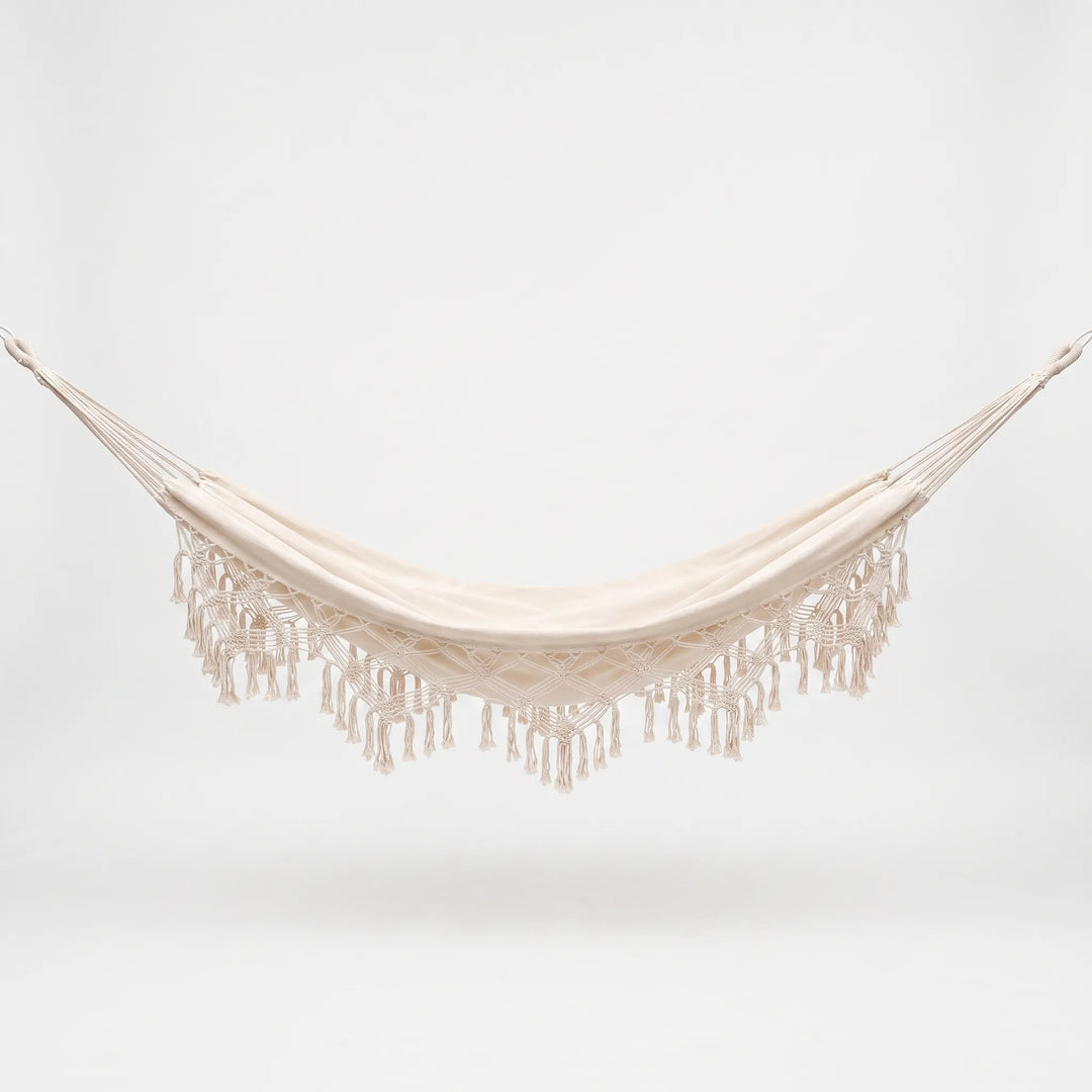 Stylish bohemian decor outdoor hanging bed hammock, perfect for a relaxing garden swing experience.