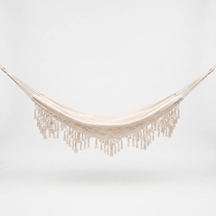 Stylish bohemian decor outdoor hanging bed hammock, perfect for a relaxing garden swing experience.