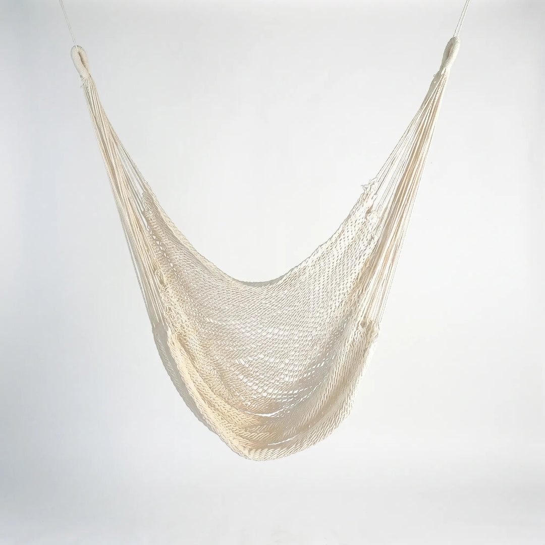 Comfortable cotton outdoor hanging hammock, bohemian tassels, perfect for garden swing and outdoor living spaces.