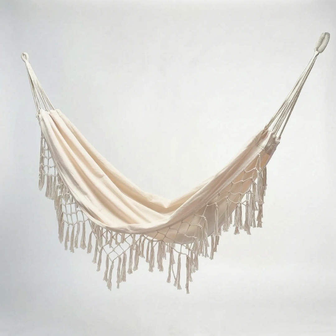 Bohemian tasseled hanging hammock for outdoor seating, garden swing chair, ideal patio furniture for relaxation.