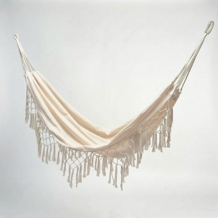 Bohemian tasseled hanging hammock for outdoor seating, garden swing chair, ideal patio furniture for relaxation.
