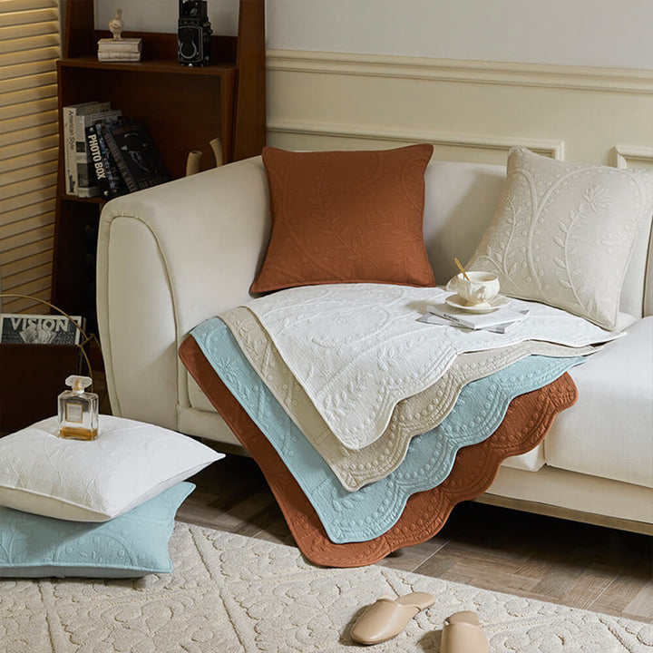 Farmhouse style sofa slipcover made from woven cotton, adding a cozy and pet-friendly touch to any room.