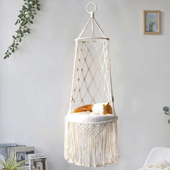 Boho macrame cat bed with soft white cushion, a cozy hanging pet hammock for cats