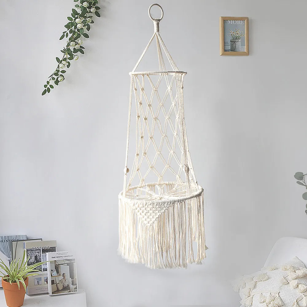 Cat enjoying a nap in a handcrafted macrame hanging bed with a cozy cushion