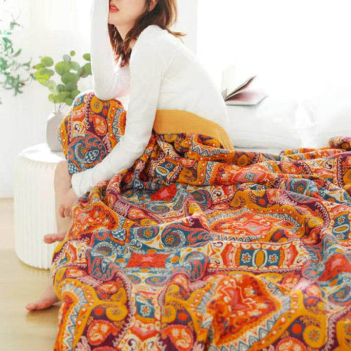 Soft quilted throw blanket featuring a reversible design, ideal for adding a bohemian touch to any bedding