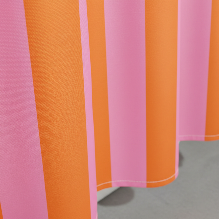 Colorful striped fabric shower curtain with boho design, adding vibrant style to modern bathrooms.