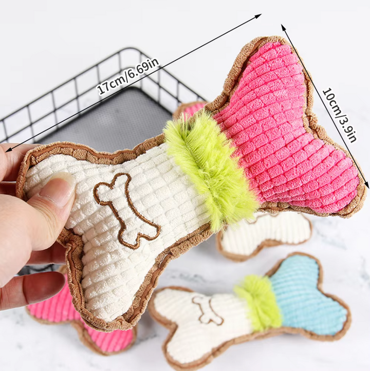 Close-up of a durable bone-shaped dog toy with squeaker, pet supplies