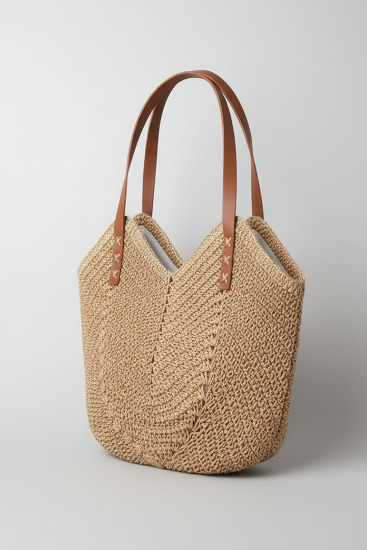 Beige textured handbag for women, featuring long handles; a stylish and comfortable shoulder bag accessory.