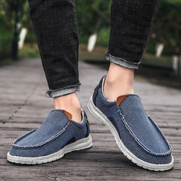 Interior view of men's comfortable Dockstone slip-on canvas shoes, highlighting cushioning for walking.