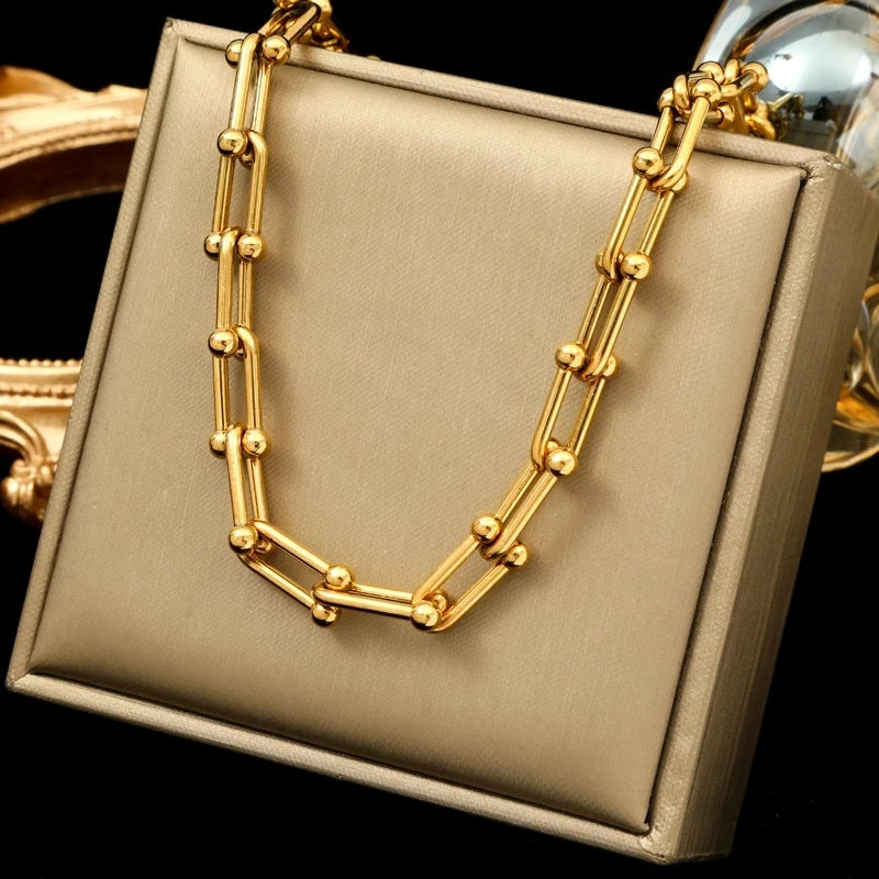 Close-up of a women's exquisite gold link chain necklace, a timeless fashion accessory.