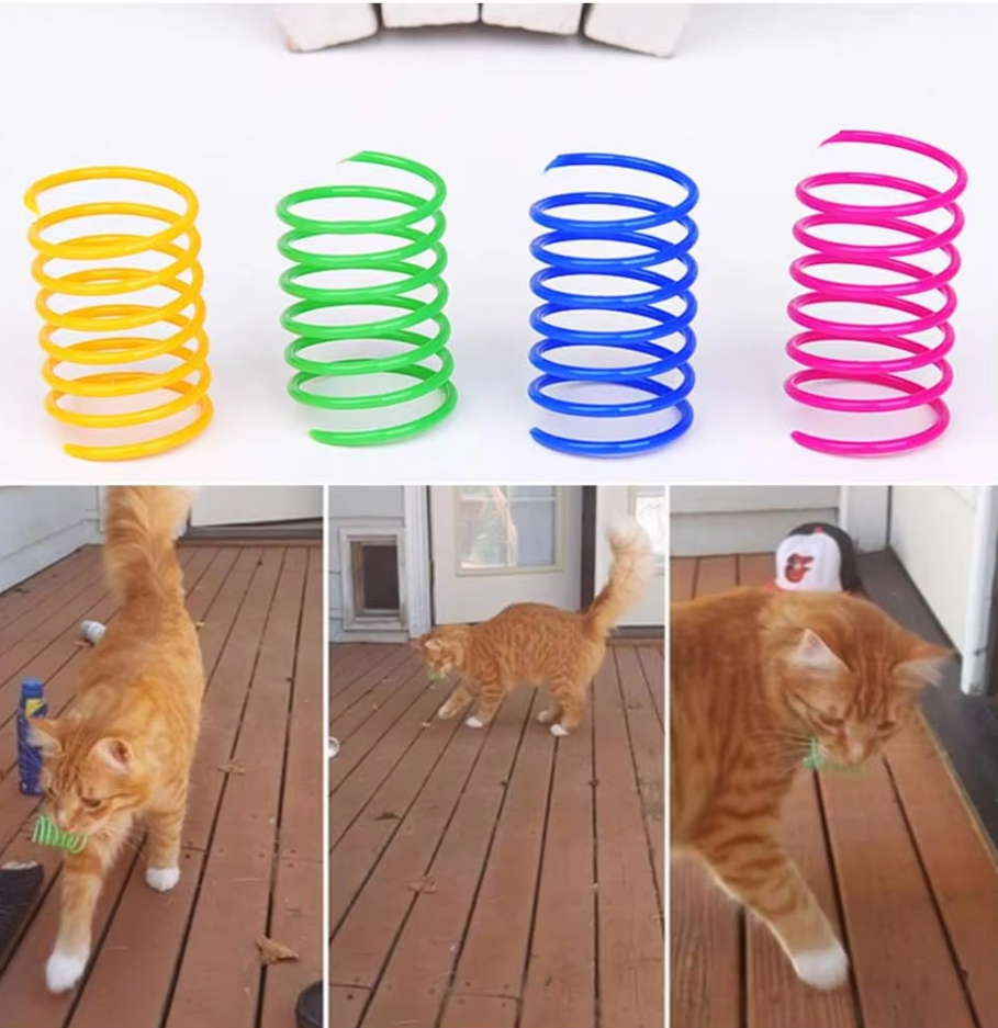 Kitten batting at a colorful spiral feather toy; an engaging interactive pet supply for active play