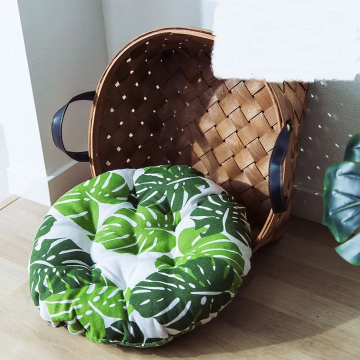 Floor cushion cat bed displaying an attractive green Monstera pattern, perfect tropical pet furniture.