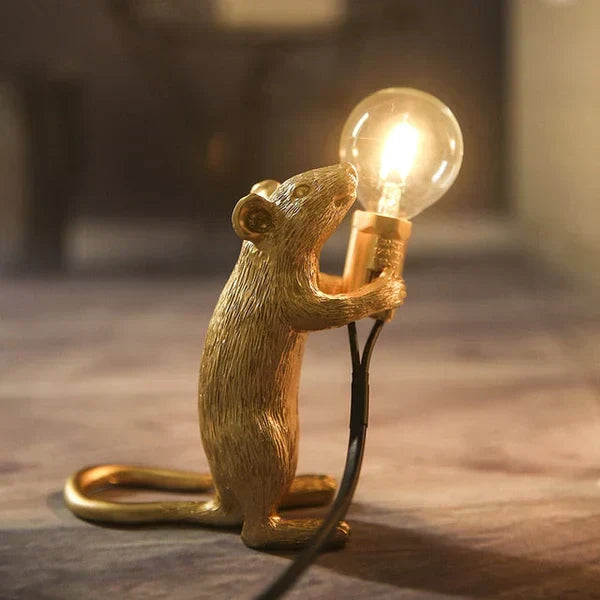 Charming gold mouse desk lamp, playful white accent light adding whimsy to any home.