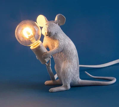 Adorable gold mouse desk lamp, whimsical white table light creating playful accent lighting.