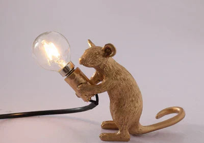 Charming mouse desk lamp, gold & white, offering playful accent lighting for home decor.