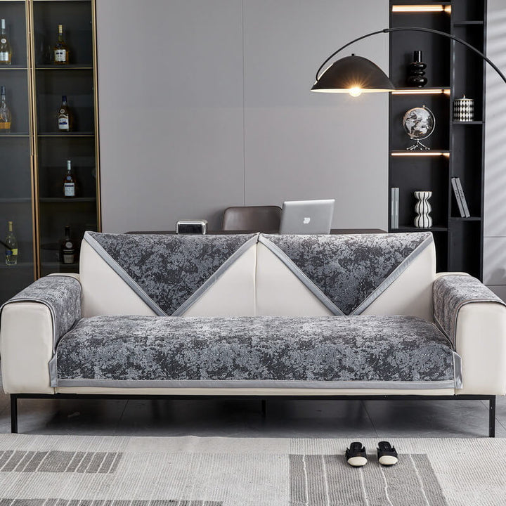 Folded chenille couch cover, highlighting its easy clean and anti-scratch properties