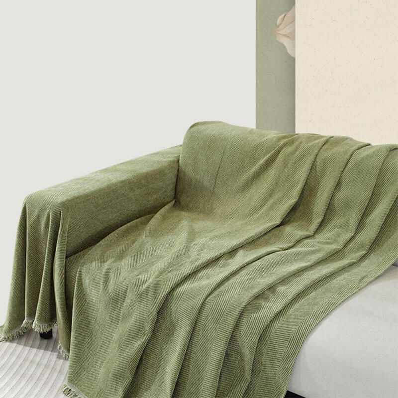 Elegant home decor: chenille herringbone couch cover with tassels providing sofa protection