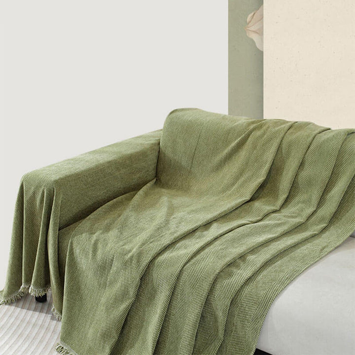 Elegant home decor: chenille herringbone couch cover with tassels providing sofa protection