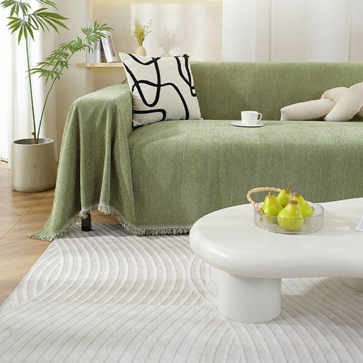 Stylish chenille sofa protector with a classic herringbone weave and charming tassels