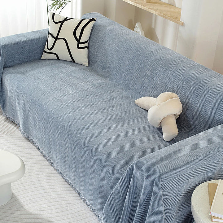 Cozy chenille throw blanket in herringbone pattern, functional as a chic couch cover with tassels