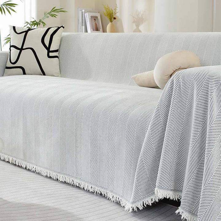 Detail of tassel fringe on a chenille herringbone couch cover, a beautiful home decor piece