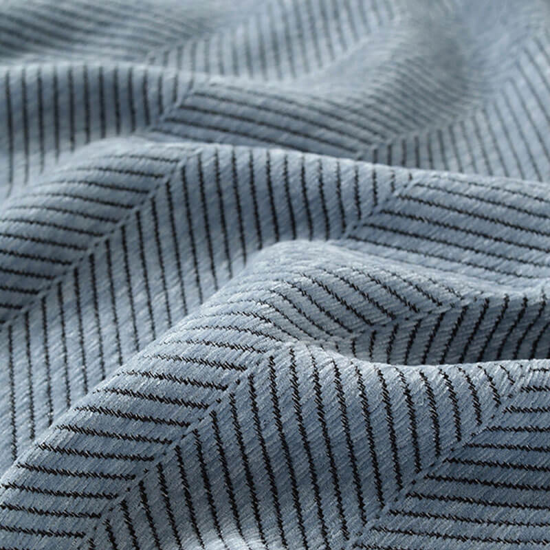Folded chenille herringbone throw blanket, ready to be used as a sofa protector or decor