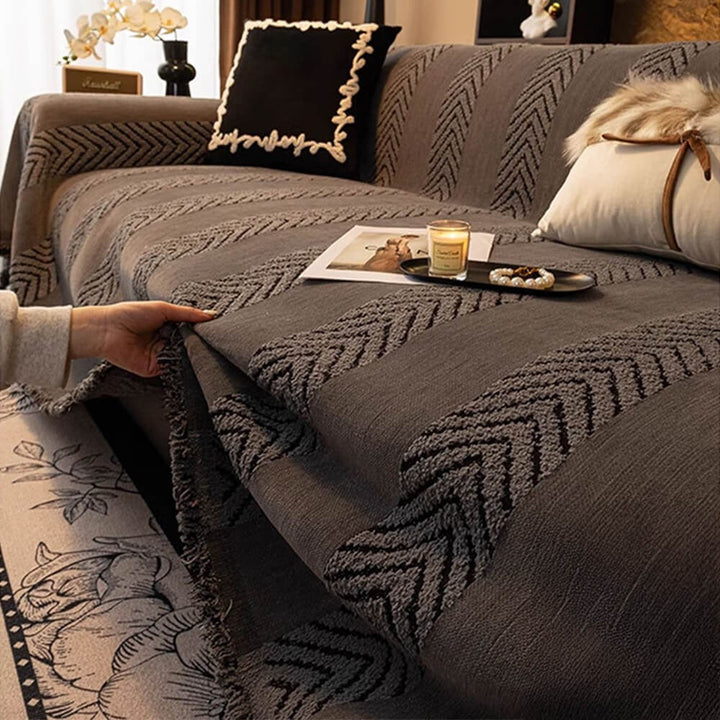 Folded chenille herringbone throw blanket, showcasing texture, for comfortable sofa protection