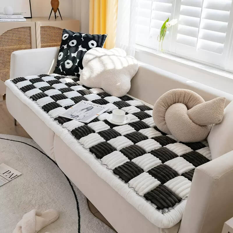 Washable pet mat on a brown sofa, protecting furniture from dogs & cats