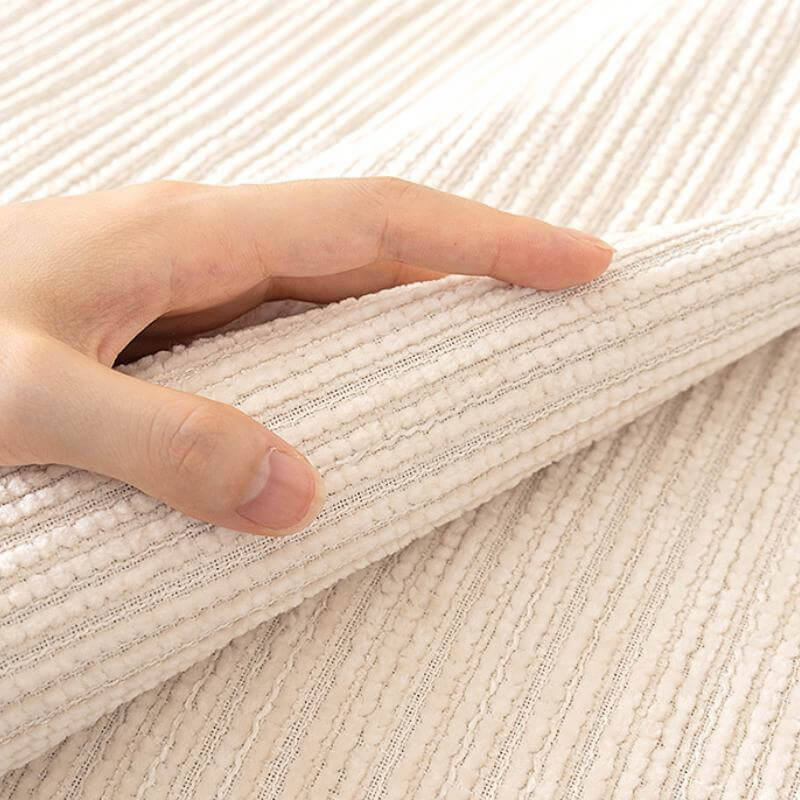 Angled view of a scratch-resistant chenille couch cover, fitting snugly over a sofa