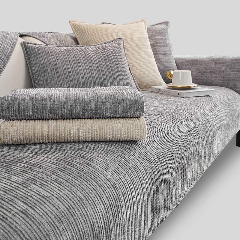 Folding a washable chenille couch cover, highlighting its ease of care and durability
