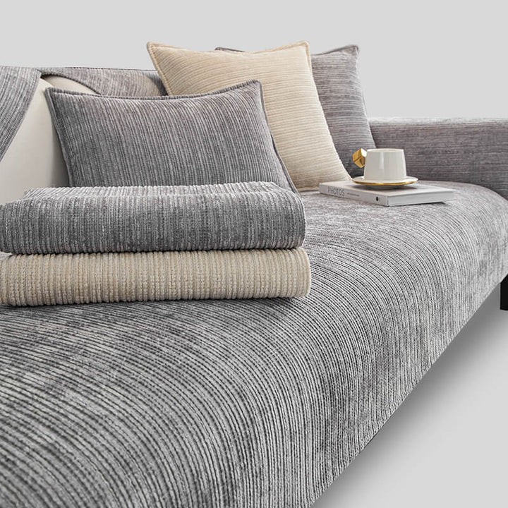 Folding a washable chenille couch cover, highlighting its ease of care and durability