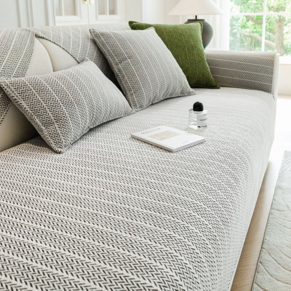 Stylish chenille sofa cover on a three-seater couch, designed for pet protection and home decor