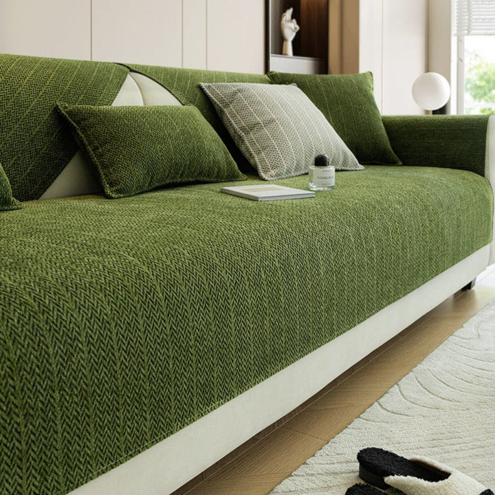 Non-slip chenille sofa cover protecting furniture from pet scratches, shown in a modern living room