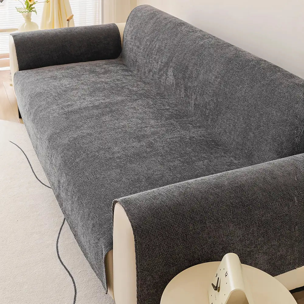 Overhead view of a neutral chenille couch protector, highlighting its non-slip design and soft texture.