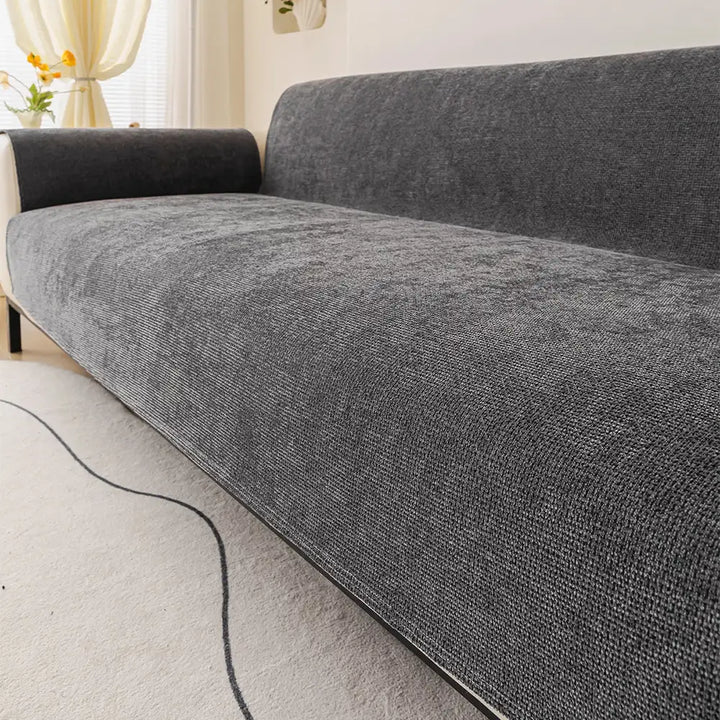 Soft chenille couch protector in a neutral color, featuring non-slip backing for furniture protection.