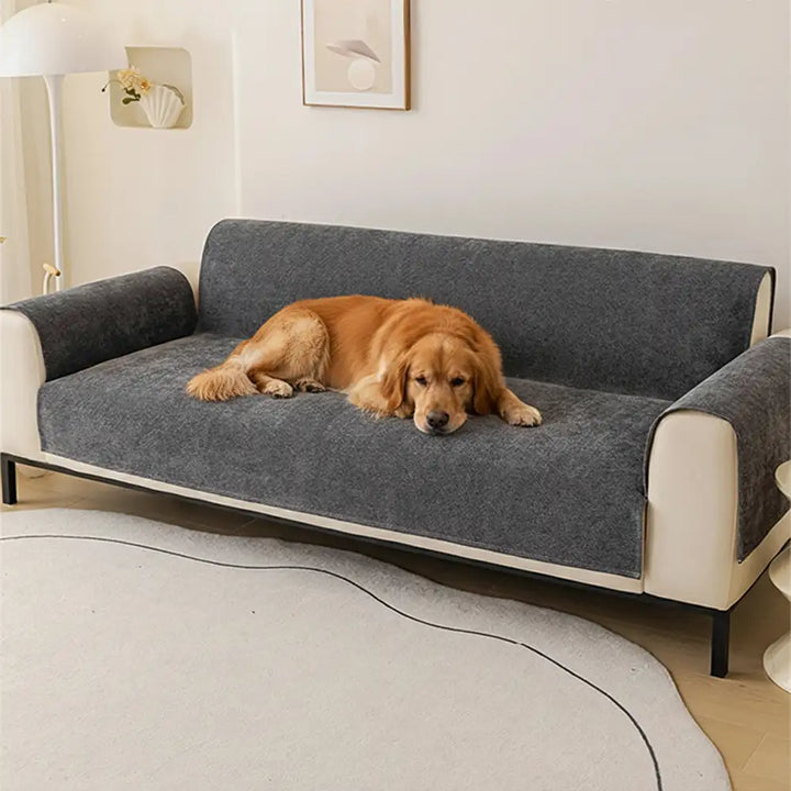 Water-repellent chenille sofa protector draped over a two-seater couch, easy-care home decor.