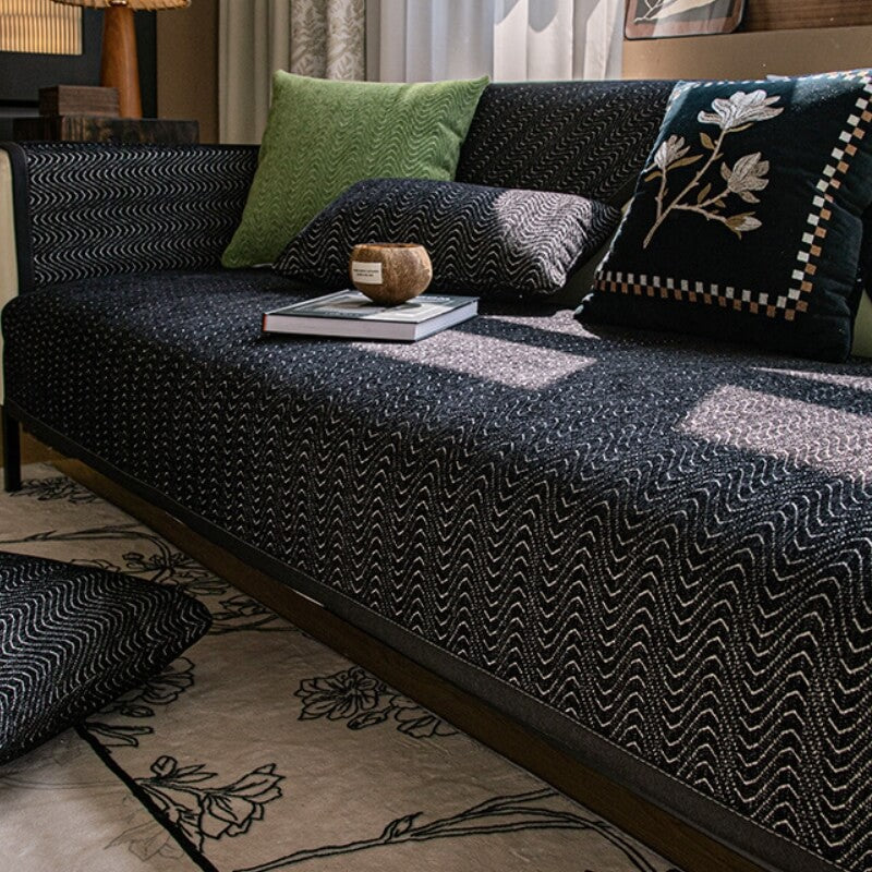 Non-slip chenille couch protector on a brown sofa, ideal for pet owners, machine washable